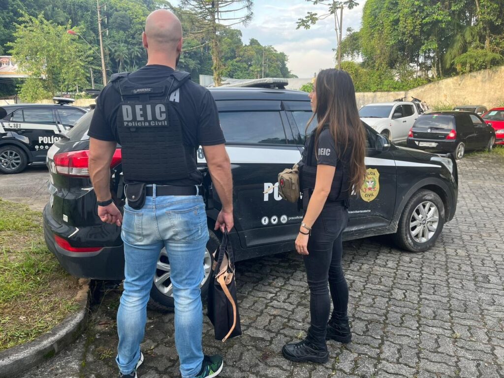 policiais da policia civil em frente da viatura de policia civil